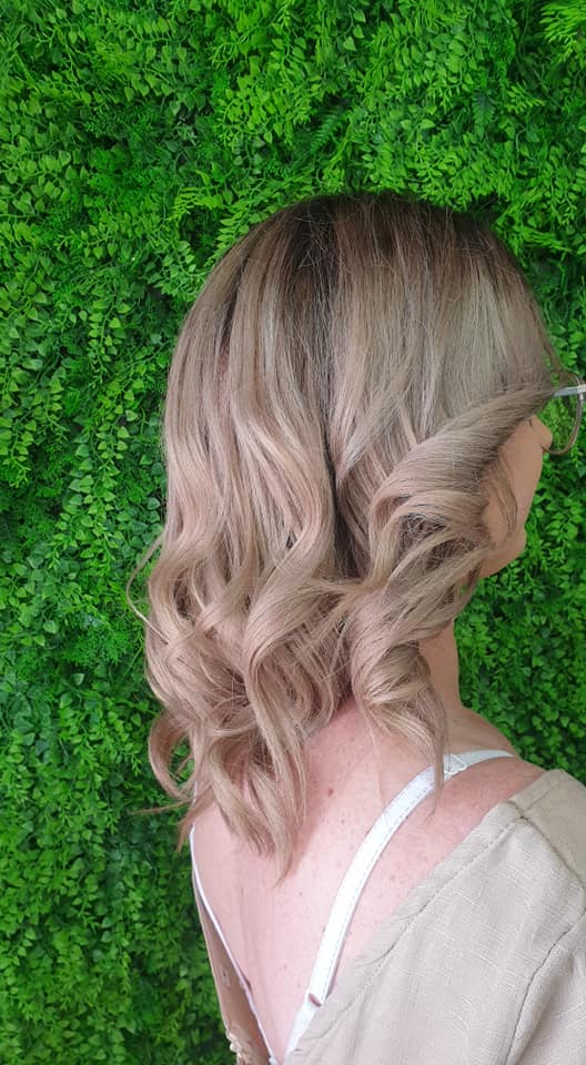 Blonde hair styled in loose curls
