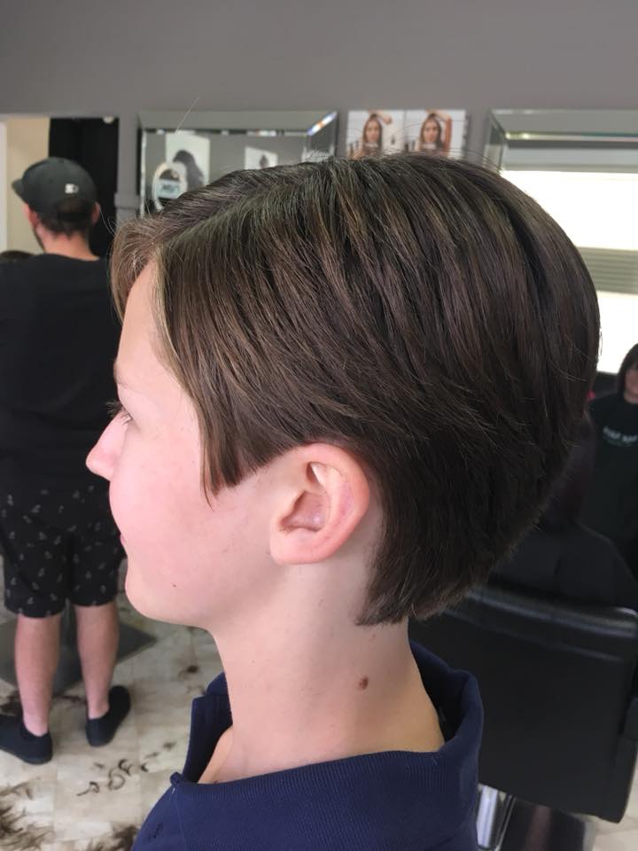 Neat short haircut on a young client, side view