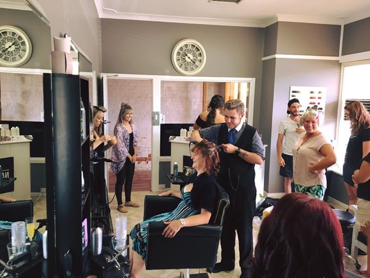 Inside Nate’s Hair, with clients in the chairs and Nate at work